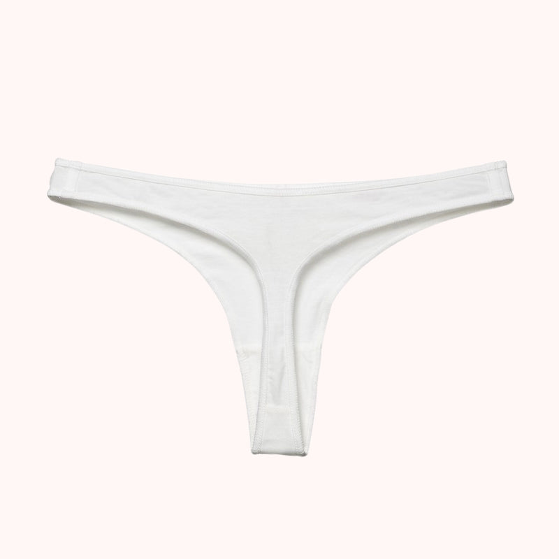NKD Essential White Thong Underwear for Women – product photo on pink background